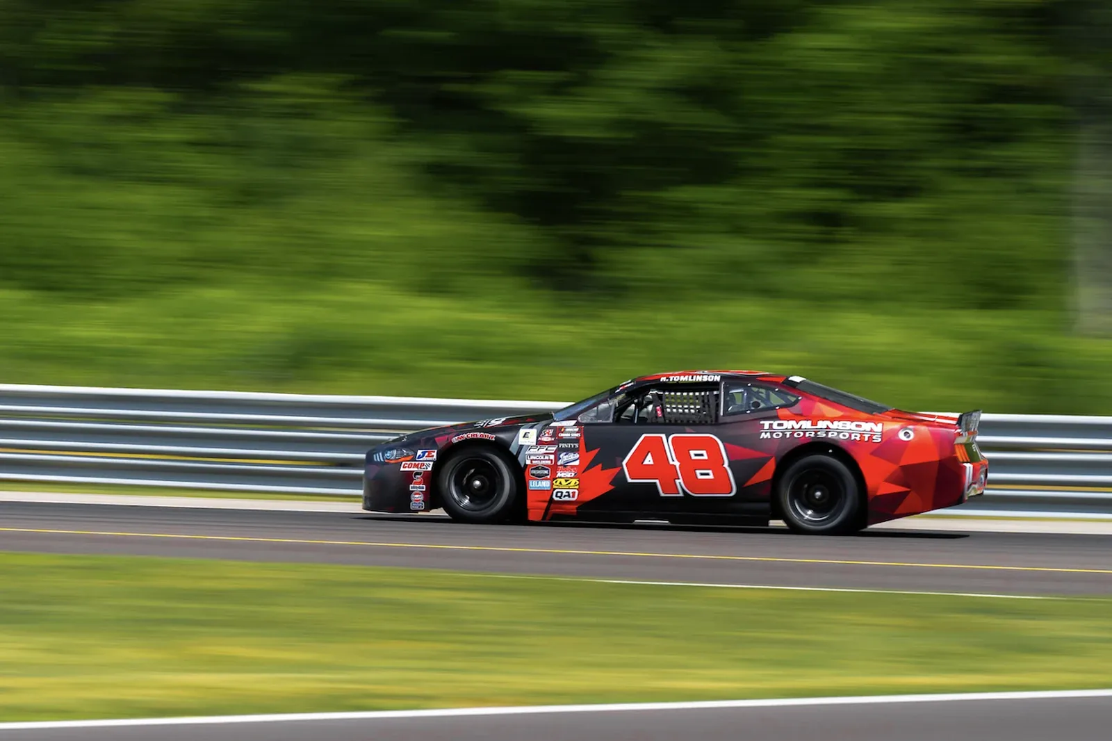 The number 48 Tomlinson Motorsports NASCAR Canada stock car at speed on the road course at Calabogie