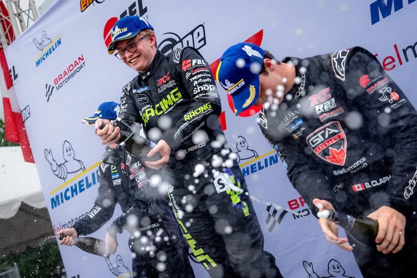 Timothe Pernod spraying champagne on the Radical Cup Canada podium at Calabogie