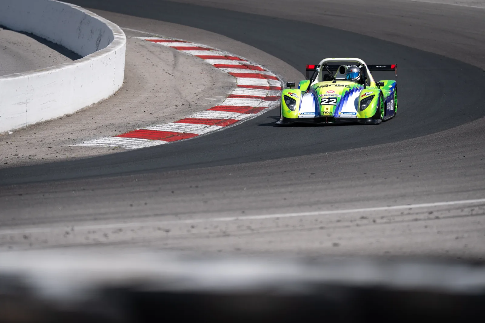 The Radical SR3 turning through a corner over the red and white curbs