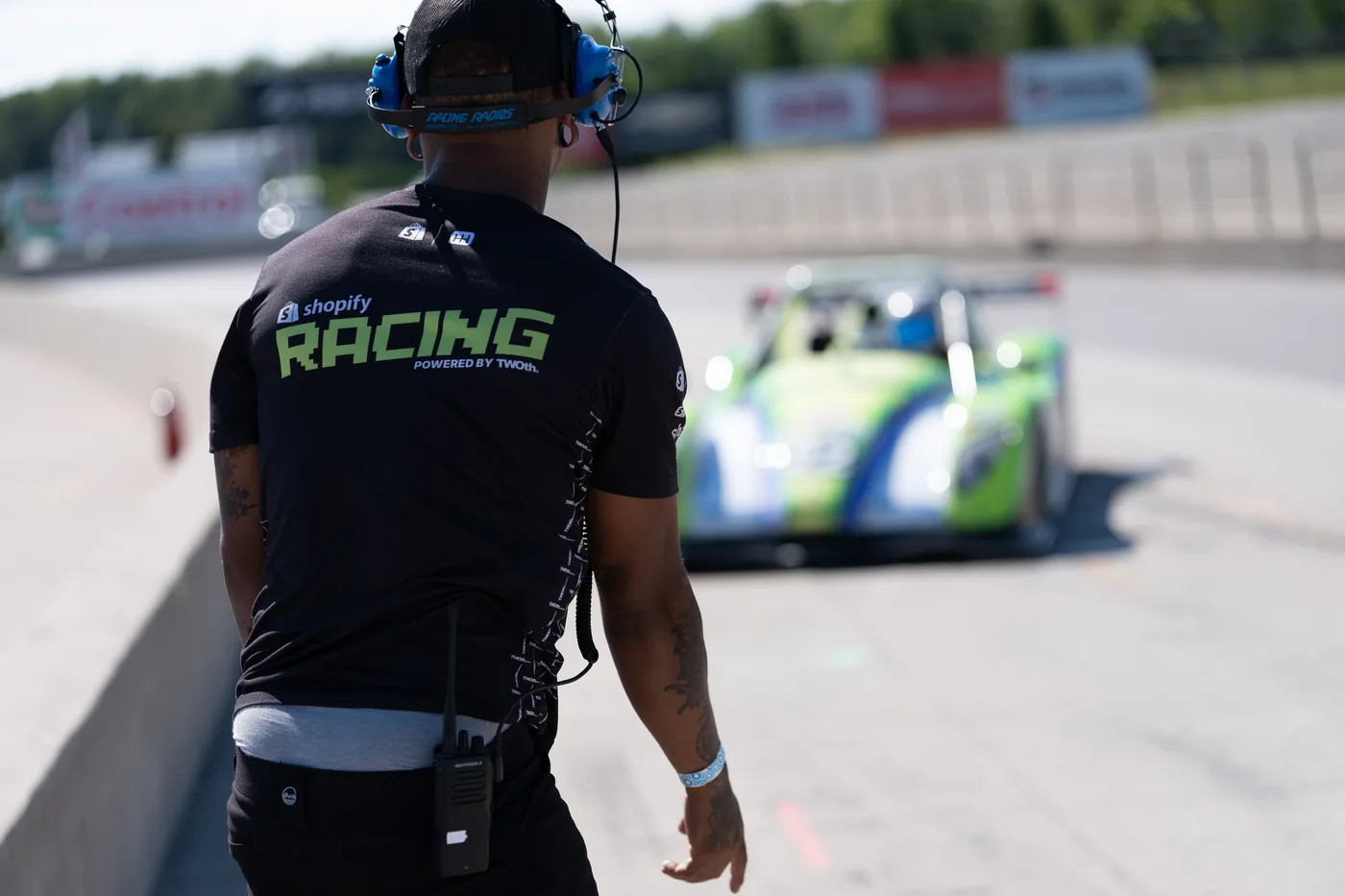 TWOth crew member watching the green Radical SR3 roll down the pit lane at Canadian Tire Motorsport Park