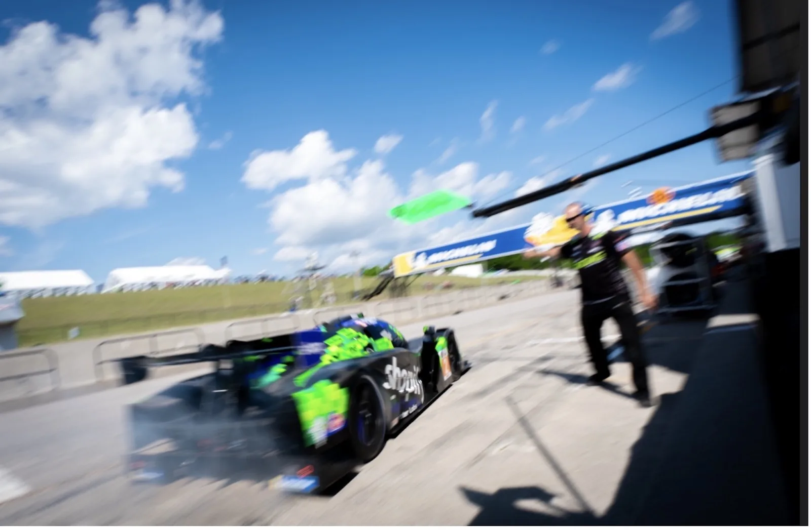 The Shopify Racing Ligier LMP3 leaving the pit lane at CTMP with a TWOth crew member trackside